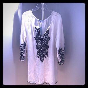 Swim cover-up with black embroidery like detail.